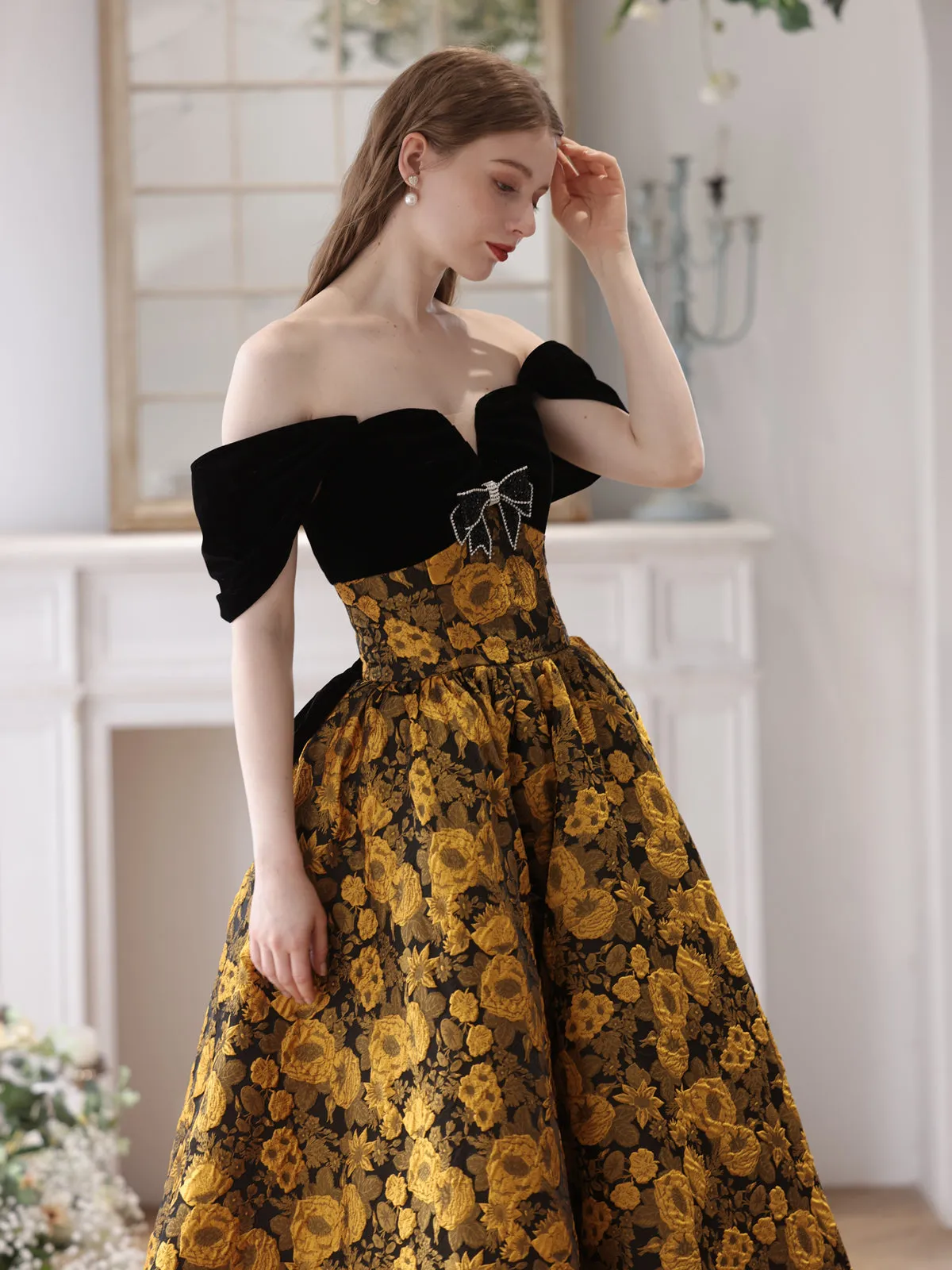 Elegant Black and Gold Floral Strapless Ball Gown with Bow Accent