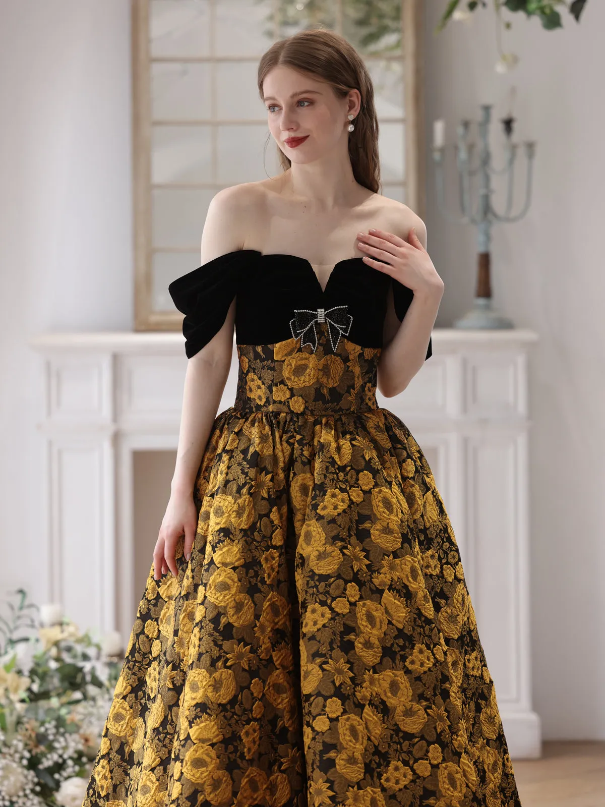 Elegant Black and Gold Floral Strapless Ball Gown with Bow Accent
