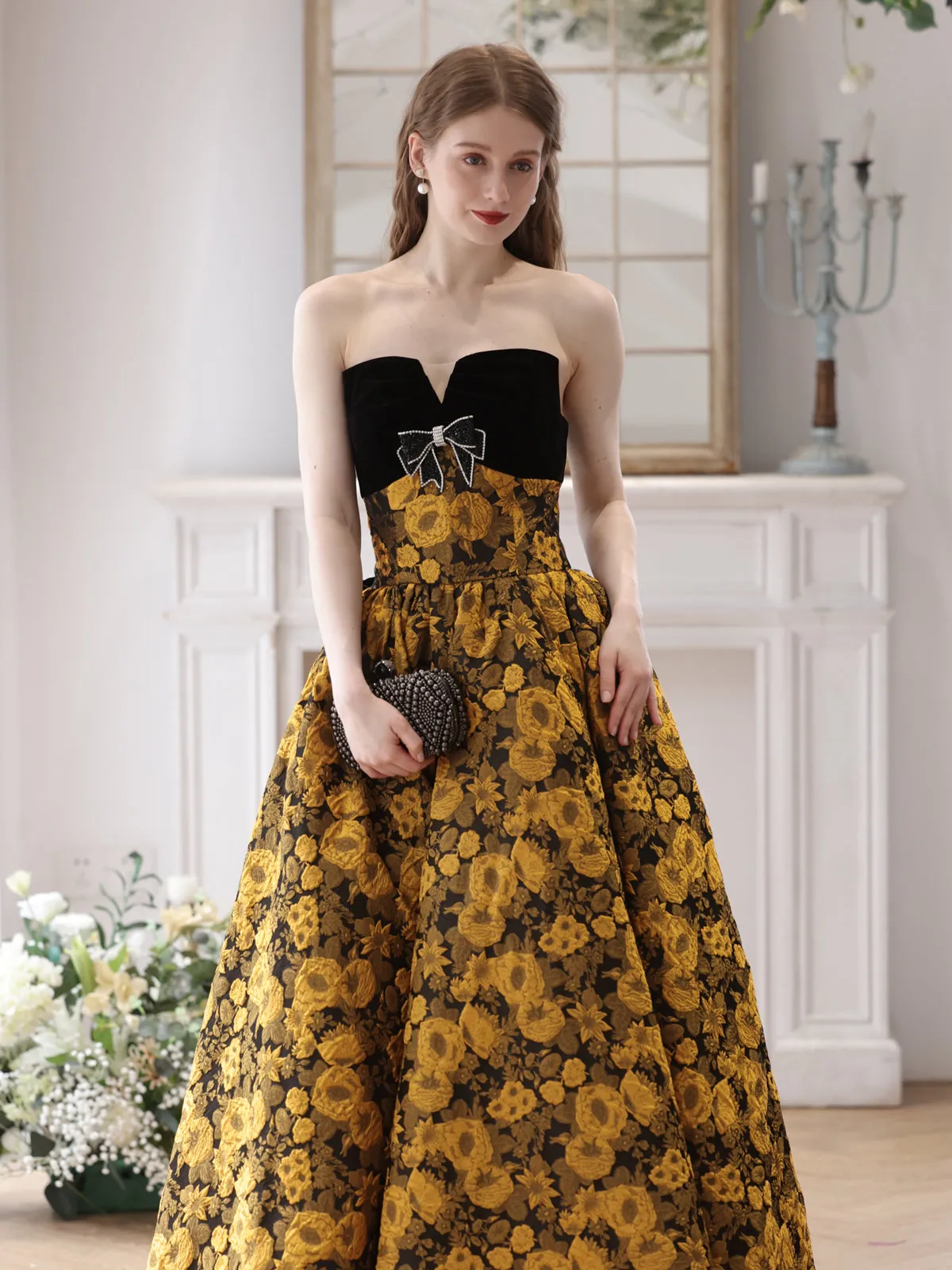 Elegant Black and Gold Floral Strapless Ball Gown with Bow Accent